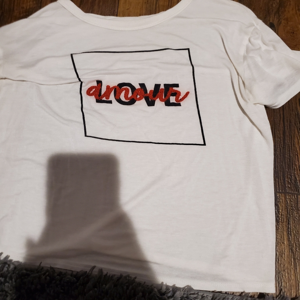 White shirt with love written on it.